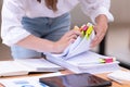 Hand of a businesswoman working for searching in Stacks of paper documents on wooden desks at the workplace Royalty Free Stock Photo