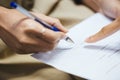 Hand of businesswoman writing on paper