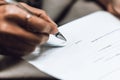 Hand of businesswoman writing on paper