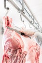 Hand of butcher in butchery cutting meat