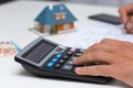 Hand on calculator - calculating household expenses