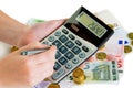 Hand with calculator and money Royalty Free Stock Photo