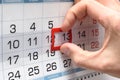 The hand on the calendar moves the pointer from the twelfth to the thirteenth