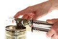 Hand and can with can opener Royalty Free Stock Photo