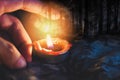 Hand with candlelight burning candle on the darkness scary forest background for Astrology Occult Magic illustration - Magic