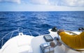 Hand of captain on steering wheel of motor boat in the blue ocean due the fishery day