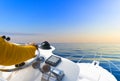 Hand of captain on steering wheel of motor boat in the blue ocean during the fishery day. Success fishing concept. Ocean yacht Royalty Free Stock Photo