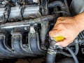 Hand of car mechanic working in auto repair service. He have fix old car engine streaked with dust and oil stains Royalty Free Stock Photo