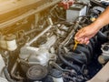 Hand of car mechanic working in auto repair service. He have fix old car engine streaked with dust and oil stains Royalty Free Stock Photo