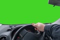 Hand on a car steering wheel. Maneuver on car, make a sharp left turn. Green screen. copy space