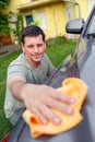 Hand car wash. Man cleaning his car using sponge and foam Royalty Free Stock Photo