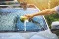Hand car wash - washing windshield with sponge Royalty Free Stock Photo