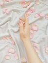 Hand care. Delicate skin on a white background. Rose petals