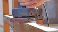 hand of carpenter using electric wood sander with sandpaper sanding a wooden Royalty Free Stock Photo