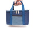 Hand carrying a blue lunch pack carrier