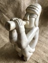 Hand Carved Peruvian White Stone Statue Figurine with Horn on Burlap Background