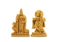 The hand-carved wooden idol of Lord Murugan with Radha Krishna is isolated on a white background Royalty Free Stock Photo