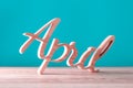 Hand carved wooden letters as April word. 1st day of april concept Royalty Free Stock Photo