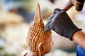 Hand of carver carving wood