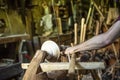 Hand carving a wooden bowl with a foot powered wood lathe, in an old carpenter`s workshop with carpenter`s wood tools Royalty Free Stock Photo