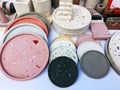 Hand cast round concrete coasters with terrazzo abstract creative pattern. Granite fragments. Stones and rocks color texture