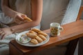 Hand catching Curry puff in white dish and Tea cup on wood Royalty Free Stock Photo