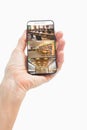 Hand of caucasian man holding smartphone with view of library from security cameras on screen