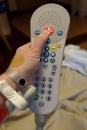 Hand of a caucasian patient pressing the call for nurse button Royalty Free Stock Photo