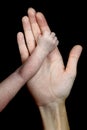 The hand of a Caucasian woman holds the small hand of her newborn child. Royalty Free Stock Photo