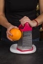 Chef rubs orange peel close-up in the kitchen Royalty Free Stock Photo