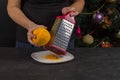 Chef rubs orange peel close-up in the kitchen Royalty Free Stock Photo