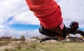 The hand of a Caucasian woman wearing cycling gloves and a pink sweatshirt, leaning against the handlebars of a bicycle