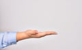 Hand of caucasian young businesswoman doing give sign with opened empty palm over isolated white backgroun