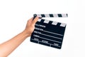 Hand of caucasian young filmmaker man holding clapboard over isolated white background Royalty Free Stock Photo