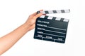 Hand of caucasian young filmmaker man holding clapboard over isolated white background Royalty Free Stock Photo