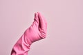 Hand of caucasian young man with cleaning glove over isolated pink background doing Italian gesture with fingers together, Royalty Free Stock Photo