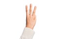 Hand of caucasian young man showing fingers over isolated white background counting number 3 showing three fingers Royalty Free Stock Photo