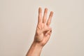 Hand of caucasian young man showing fingers over isolated white background counting number 3 showing three fingers Royalty Free Stock Photo