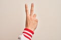 Hand of caucasian young man showing fingers over isolated white background counting number 2 showing two fingers, gesturing Royalty Free Stock Photo