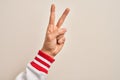 Hand of caucasian young man showing fingers over isolated white background counting number 2 showing two fingers, gesturing Royalty Free Stock Photo