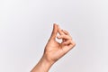 Hand of caucasian young man showing fingers over isolated white background snapping fingers for success, easy and click symbol