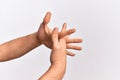 Hand of caucasian young man showing fingers over isolated white background stretching with fingers intertwined, hands together and