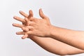 Hand of caucasian young man showing fingers over isolated white background stretching them with fingers intertwined, hands