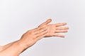 Hand of caucasian young man showing fingers over isolated white background touching palms gentle, delicate beauty pose