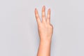 Hand of caucasian young woman counting number 3 showing three fingers Royalty Free Stock Photo