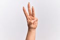 Hand of caucasian young woman counting number 3 showing three fingers Royalty Free Stock Photo