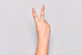 Hand of caucasian young woman counting number 2 showing two fingers, gesturing victory and winner symbol Royalty Free Stock Photo