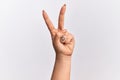 Hand of caucasian young woman counting number 2 showing two fingers, gesturing victory and winner symbol Royalty Free Stock Photo