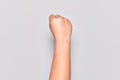 Hand of caucasian young woman doing protest and revolution gesture, fist expressing force and power Royalty Free Stock Photo