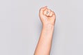 Hand of caucasian young woman doing protest and revolution gesture, fist expressing force and power Royalty Free Stock Photo